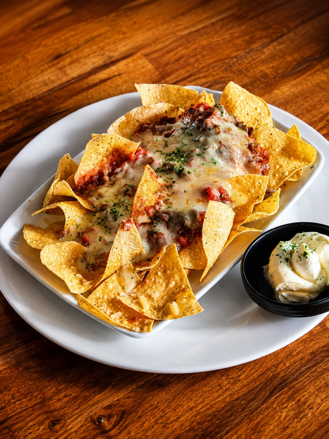 Loaded nachos with melted cheese and sour cream